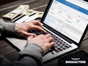 man looking at financials on computer - what is a sportsbook