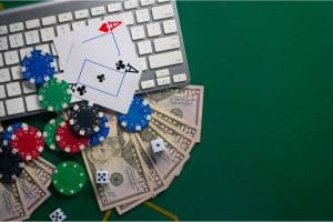 Online Casinos and Sportsbooks - Computer with cards, chips and money